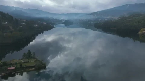 Aerial shot of the reflection of the cloudy sky in the calm water Stock Footage 235364504