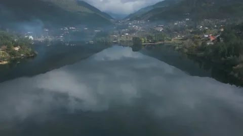Aerial shot of the reflection of the cloudy sky on a river in Portugal Stock Footage 235365458