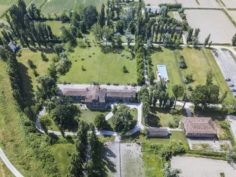 Aerial shot of a residential plot with a large house surrounded by trees Fotos de archivo