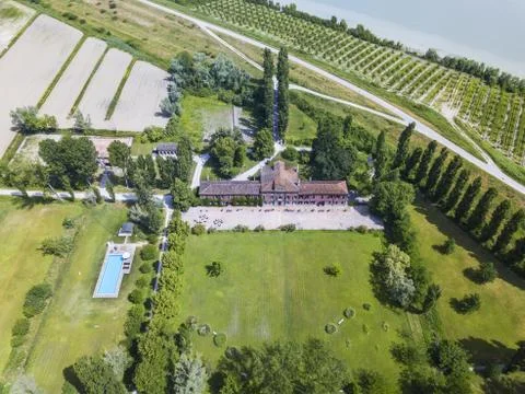 Aerial shot of a residential plot with a large house surrounded by trees 스톡 사진