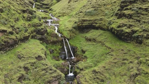 Aerial shot of a river and small waterfalls going through a canyon in South Icel Stock Footage