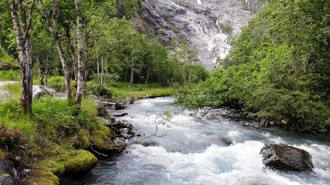 Aerial shot of the river flowing down the glacier Stock Footage 119438331