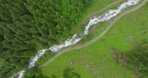 Aerial shot of a river flowing down the mountain Stock Footage 283567067