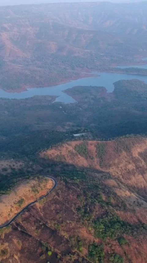 Aerial shot of river running between hills with tropical forest at sunset Stock Footage 226878674