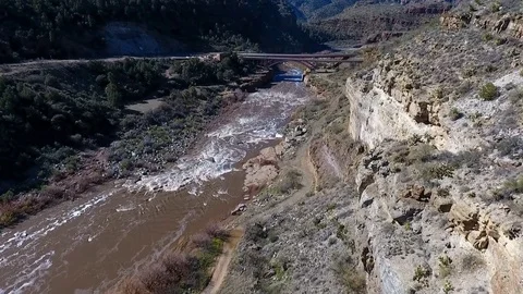 Aerial shot of a river running through a desert canyon Stock Footage 72985642