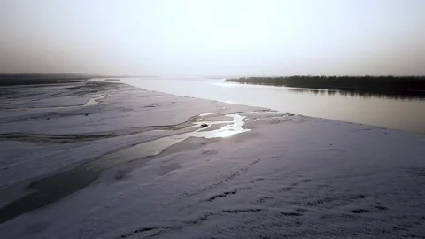 Aerial shot  of river surface in winter sunset, ice and snow river 스톡 동영상 234306462