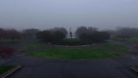 Aerial shot of the Rocket Thrower, a 1963 bronze sculpture and the Unisphere on Stock Footage 333405443