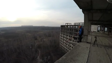 Aerial Shot: Rope Jumping From a Ledge of buliding 動画素材 58249934