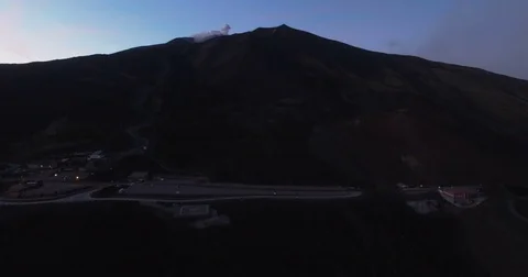 Aerial shot rotating around Mount Etna at night Stock Footage 77098246