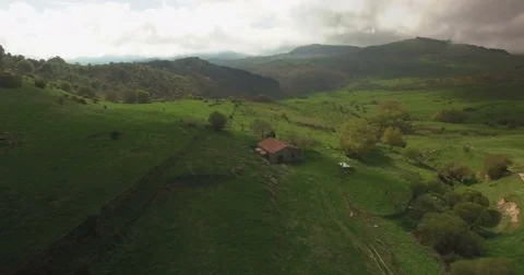 Aerial shot rotating around a small farm house Stock Footage 77061284