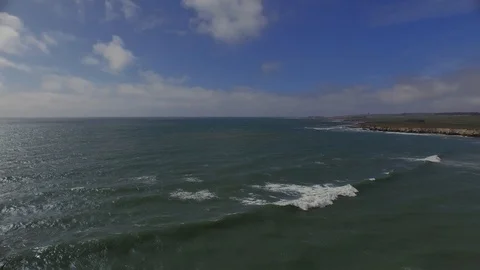 Aerial shot, rotating clockwise over waves back toward beach 001621 DJI_0001.mp4 Stock Footage 90642929