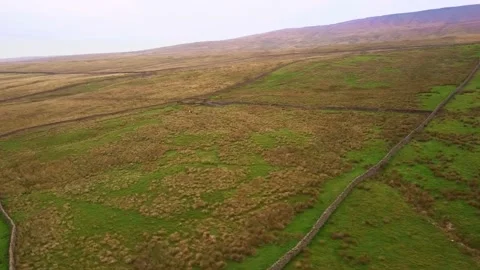 Aerial shot rotating inside Yorkshire Dales valley patchwork fields Video stock 227501690
