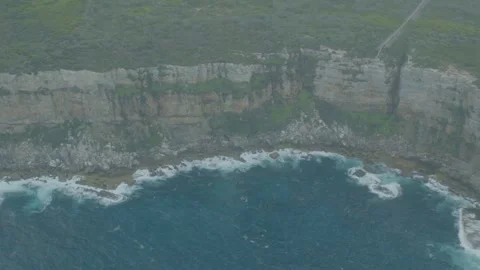Aerial Shot of Rugged Coastal Cliffs and Ocean Waves in New South Wales Stock Footage 345737034