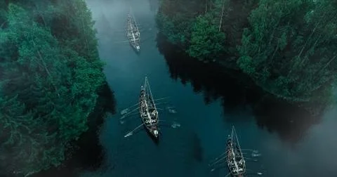 Aerial Shot of a Sailing Viking Row Ships on River. Medieval Reenactment. Stock Photos