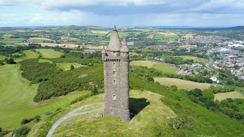 Aerial shot of Scrabo Tower on a sunny day in Belfast, Northern Ireland Stock Footage