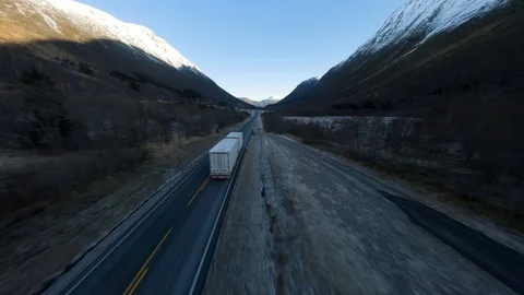 Aerial shot of semi truck driving down a mountain road in high speed. Stock Footage