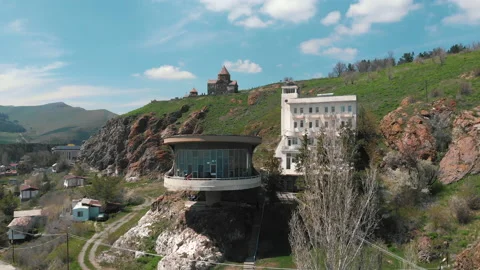 Aerial shot of the The Sevan Writers House under the sunlight in Armenia Stock Footage 195332648