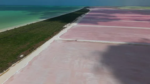 Aerial shot of shadows of clouds moving over pink salt lakes Stock-Footage 310175029