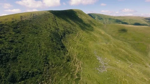 Aerial shot of a sharp and long Carpathian mountain with a cloud shade in summer Stock Footage 93848602