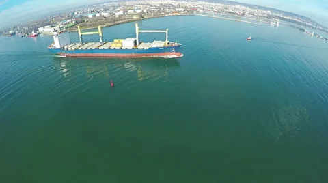 Aerial shot of ship leaving the trade harbor to the open ocean. 스톡 동영상 59759113