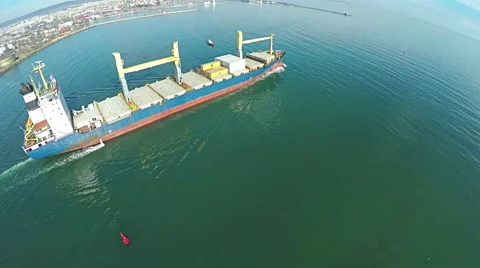 Aerial shot of ship leaving the trade harbor to the open ocean. Vidéo 59759393