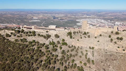Aerial Shot Showing Full Width of Santa Catalina Castle on Mountain Ridge Stock Footage 311640971