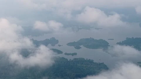 Aerial shot shows clouds moving over distant islands Vidéo 339846104