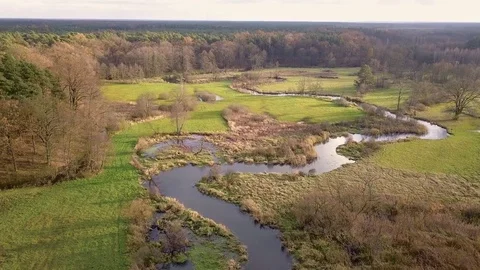 Aerial shot of small, curvy river in Autumn. Video stock 82432330
