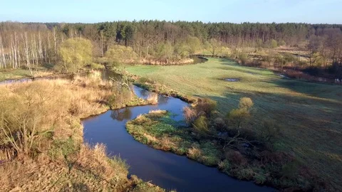 Aerial shot of small, curvy river. Small river seen from above in spring light. Stock Footage 88601764