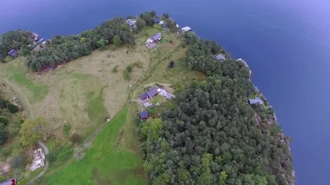 Aerial shot small fishing village on the shore of a beautiful blue clean sea in Stock Footage