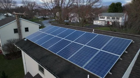 Aerial shot of small solar panel array on home in USA. Photovoltaic array Stock Footage 234968714