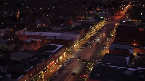Aerial shot of small town USA during Christmas time at night Stock Footage 59169613