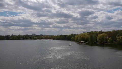 Aerial shot small  train sailing yacht float city park lake Stock Footage 107706200