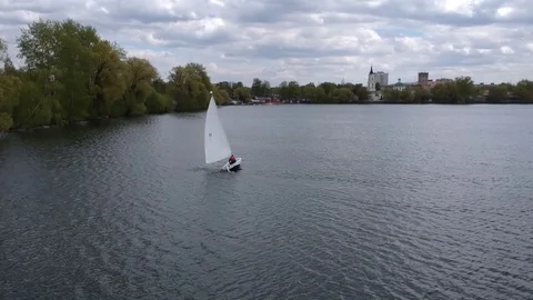 Aerial shot small  train sailing yacht float city park lake Stock Footage 107706258