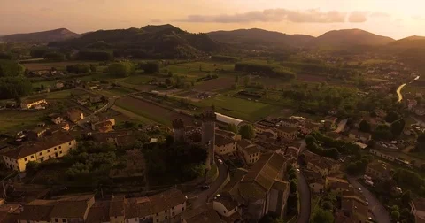 Aerial shot, a small tuscan hamlet Nozzano castello on the hill in the sunset Stock Footage