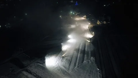 Aerial shot: The snow cannon's makes artificial snow at night. Winter sports 스톡 동영상 100711545