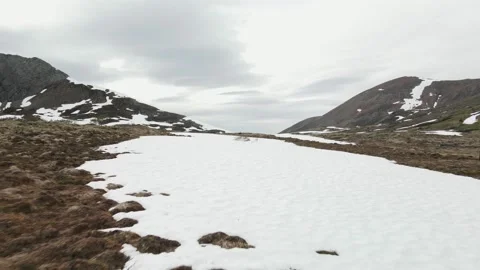 Aerial shot of a snow patch on a mountain top Stock Footage 161431264