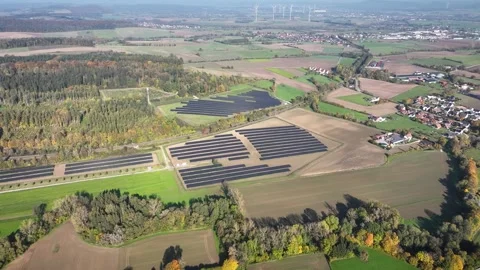 Aerial shot of solar park's structured layout with panels in varied patterns. Stock-Footage 291079040