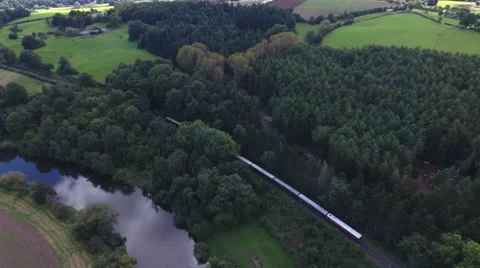 Aerial shot of a steam train through the woods. Stock Footage 68668376