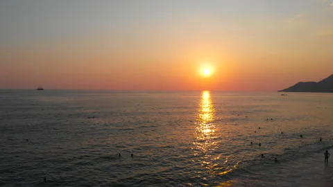 Aerial shot of the sun setting over the ocean horizon. sea waves Video stock 130452572