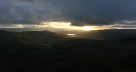 Aerial shot of sunrays breaking through the clouds Stock Footage 275803342