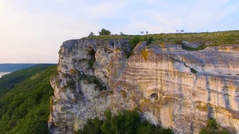 Aerial shot of a sunset near rocks. Vivid colors are reflected in the water Stock Footage