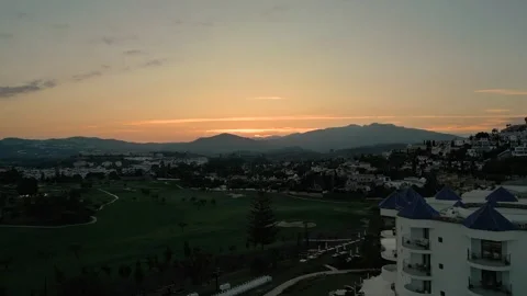 Aerial shot sunset over a withe palace in Spain with mountain in the background Stock Footage 282799163