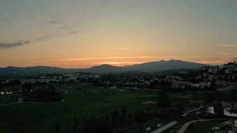 Aerial shot  sunset over a withe palace in Spain with mountain in the background Stock Footage 282799174