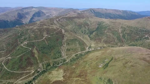 Aerial shot of three round looking mountains in the Carpathians on a sunny day Stock Footage 86800023