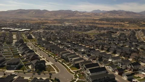 Aerial shot tilting down on dense suburban housing development with park Stock Footage 130667463
