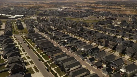 Aerial shot tilting down on dense suburban housing development with park Stock Footage 146924819