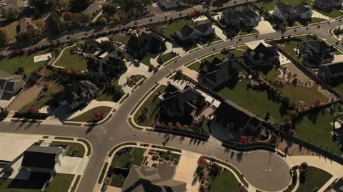 Aerial shot tilting up from upper class suburban neighborhood to reveal valley Stock Footage 130667352