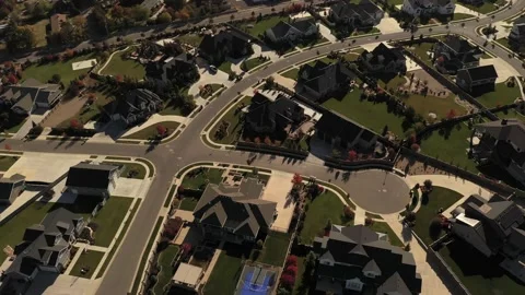 Aerial shot tilting up from upper class suburban neighborhood to reveal valley Stock Footage 146923773
