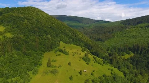 Aerial shot of a tiny house on the meadow of the Carpathians in summer Stock Footage 90451130